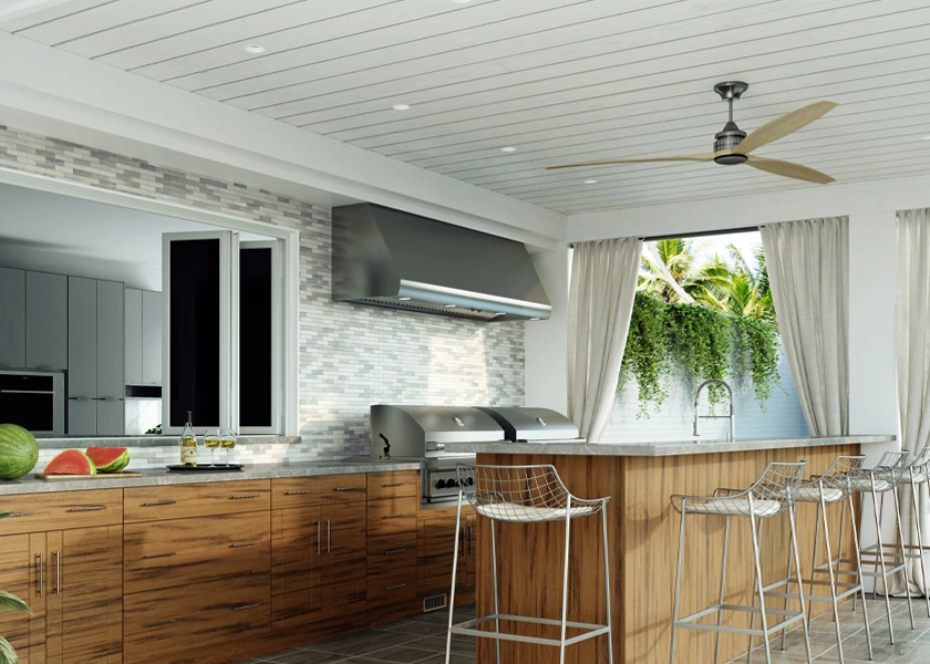 Outdoor kitchen with bar seating beside a pool