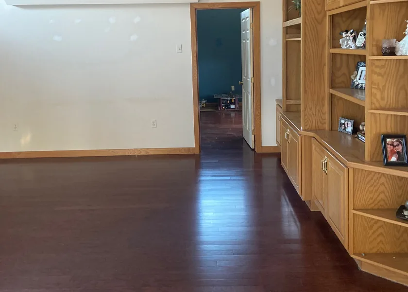Hardwood flooring running up to built-in shelving