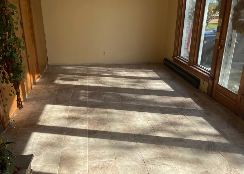 Large-format tile flooring in a sunlit living space