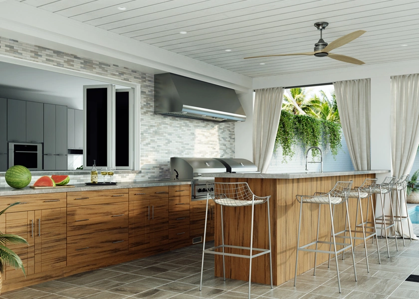 Outdoor kitchen with island seating under a covered patio