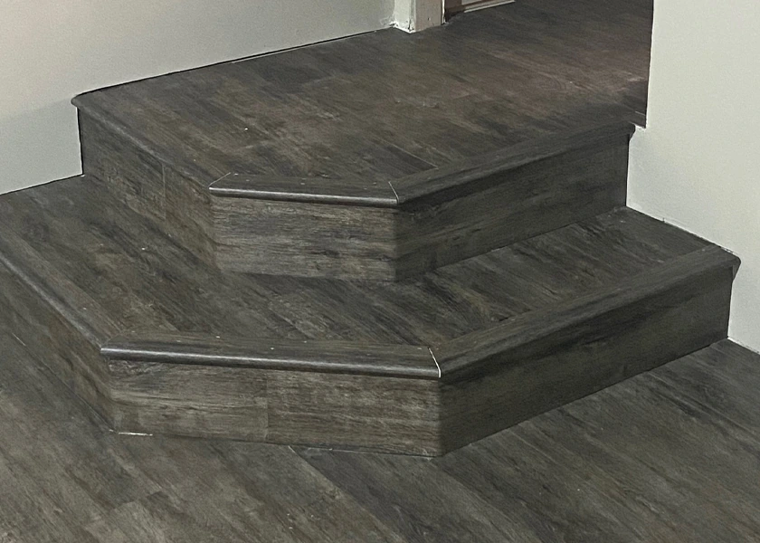 Tiled stair treads in wood-look plank tile