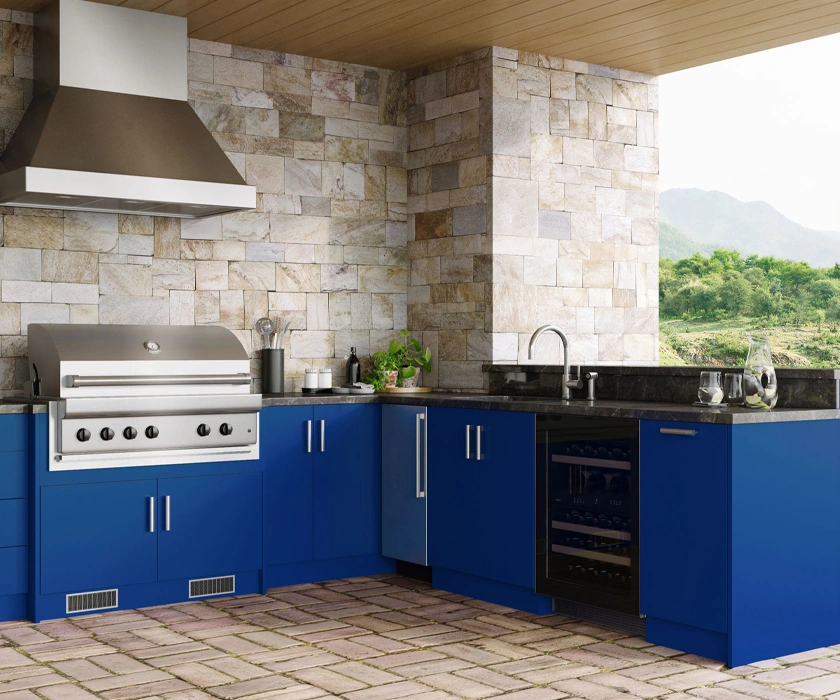 Outdoor kitchen with a stone surround and vent hood